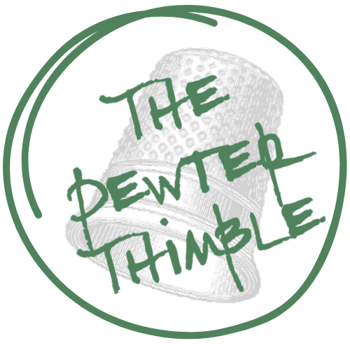 The Pewter Thimble logo: an illustration of a gray thimble, with "The Pewter Thimble" written in dark green